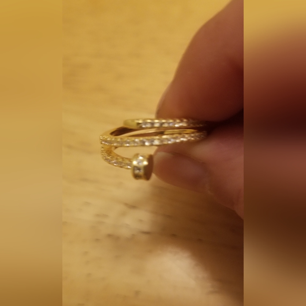 14 kt gold plated ring with shiny cubic zirconia. Just like a Cartier's ring.
